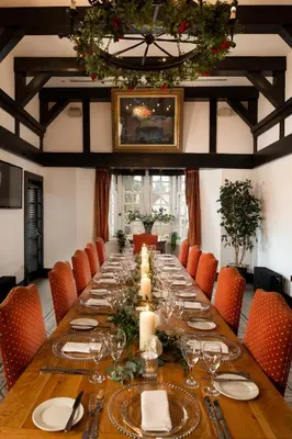 a long table in a room with orange chairs at Brig o' Doon House Hotel in Ayr