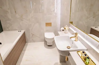 a bathroom with a sink and a tub and a toilet at Brig o' Doon House Hotel in Ayr