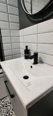 a bathroom sink with a soap dispenser on it at Anchors Rest in Ayr