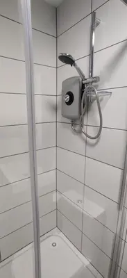 a shower with a soap dispenser on a wall at Anchors Rest in Ayr
