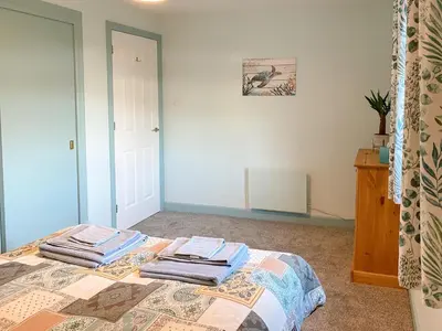 a bedroom with a bed with towels on it at Ardwell Park in Ardwell