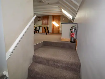 a stairway leading to a room with a fire hydrant at Old School Muncaster House in Ravenglass