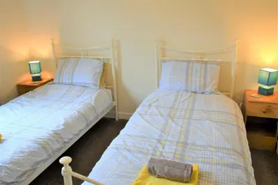 two beds sitting next to each other in a bedroom at Springfield in Dalbeattie