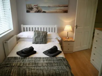 a bedroom with two beds with towels on it at Firpoint in Rockcliffe