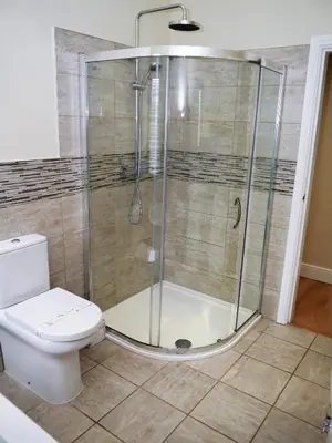 a bathroom with a shower and a toilet at Firpoint in Rockcliffe
