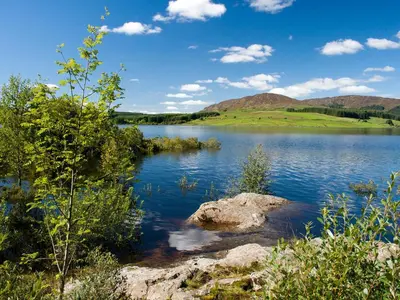 a view of a lake with mountains in the background at Park Crescent - Cottage in Creetown