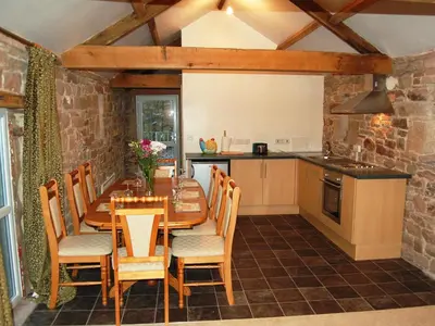 a kitchen and dining room with a table and chairs at The Bird Bath - Cottage in Wreay