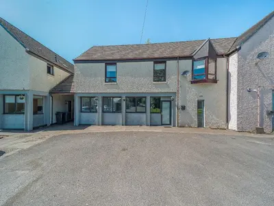 an empty parking lot in front of a house at 3 Ladyknowe Uk39969 in Moffat