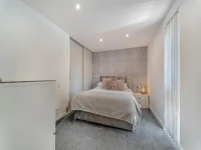 a white bedroom with a bed and a window at 3 Ladyknowe Uk39969 in Moffat