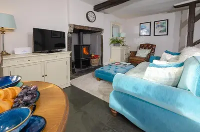 a living room with a blue couch and a tv at Bank View in Chapel Stile