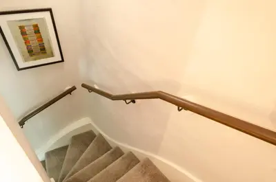 a staircase with a hand rail in a stair case at Bank View in Chapel Stile