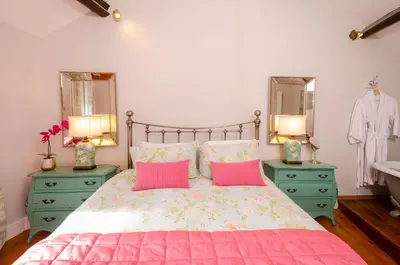 a bedroom with a bed and two mirrors and a sink at Bank View in Chapel Stile