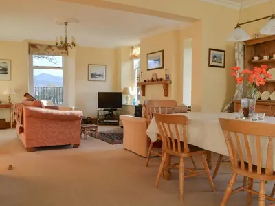 a living room with a table and chairs at Middle Howe in Portinscale
