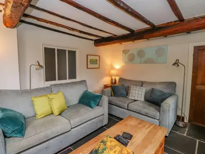 a living room with two couches and a coffee table at Fir Tree Cottage in Ambleside
