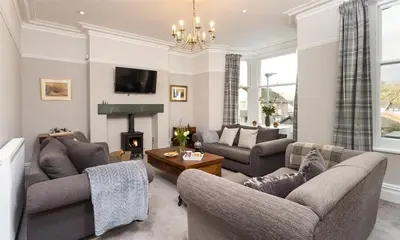 a living room with two couches and a fireplace at Thirty Blencathra Street in Keswick