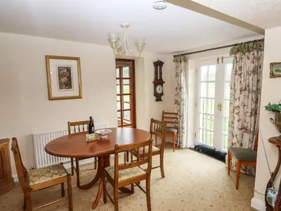 a dining room with a table and chairs at Pavement End Cottage in Grasmere