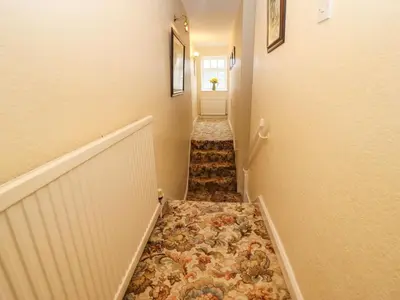 a hallway with a tile floor in a house at Pavement End Cottage in Grasmere