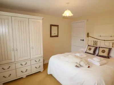 a bedroom with a white bed with towels on it at Pavement End Cottage in Grasmere