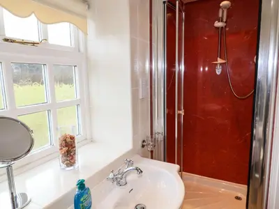 a bathroom with a sink and a shower at Pavement End Cottage in Grasmere