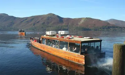 a group of people on a boat on the water at Agathi in Keswick