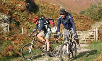 two people riding bikes on a mountain trail at Agathi in Keswick