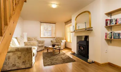 a living room with a couch and a fireplace at Agathi in Keswick