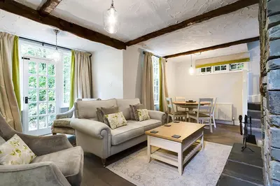 a living room with a couch and a table at Acorn Cottage in Grasmere