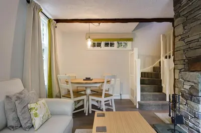a living room with a table and a table and chairs at Acorn Cottage in Grasmere