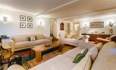 a living room with couches and a coffee table at Thimble Hall in Grasmere