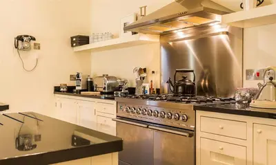 a kitchen with a stainless steel stove top oven at Thimble Hall in Grasmere