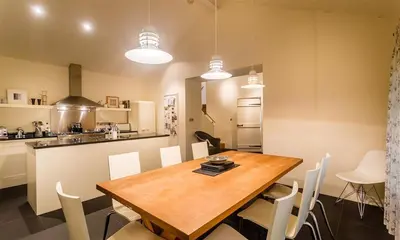 a kitchen and dining room with a wooden table and chairs at Thimble Hall in Grasmere