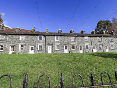 a large brick building with a grass field in front of it at Slaters Rest in Chapel Stile