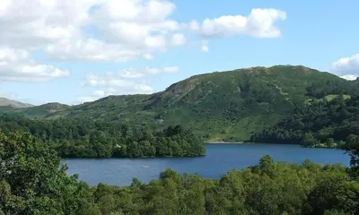 a view of a lake in front of a mountain at Riverville in Grasmere