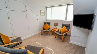 a waiting room with chairs and a flat screen tv at Bowderstone in Keswick