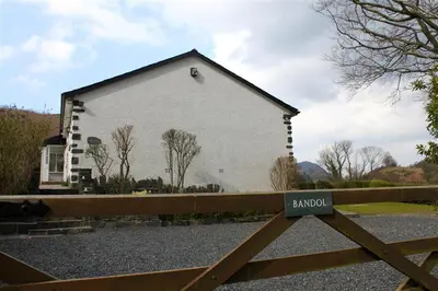 a white building with a sign in front of it at Bandol in Braithwaite