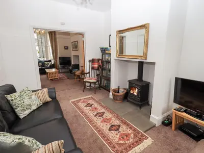 a living room with a couch and a fireplace at Number Twenty in Keswick