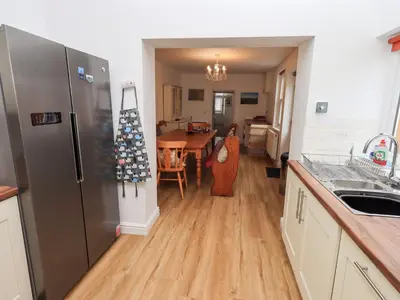 a kitchen with a refrigerator and a table in it at Number Twenty in Keswick