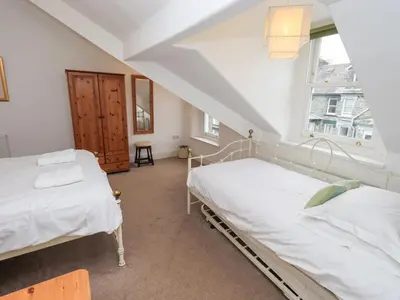 two beds in a room with a window at Number Twenty in Keswick