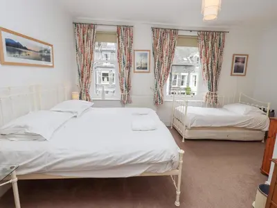 a bedroom with two beds and a window at Number Twenty in Keswick
