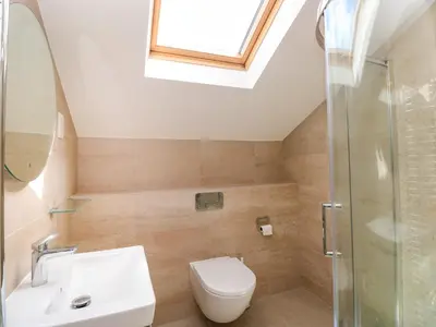 a bathroom with a toilet and a sink and a shower at Rowanberry Cottage in Grasmere