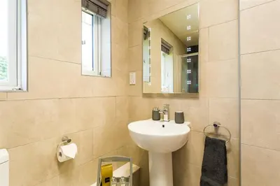 a bathroom with a sink and a mirror at Greengarth in Keswick