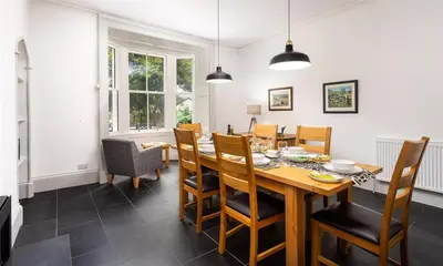 a dining room with a wooden table and chairs at Ben House in Grasmere