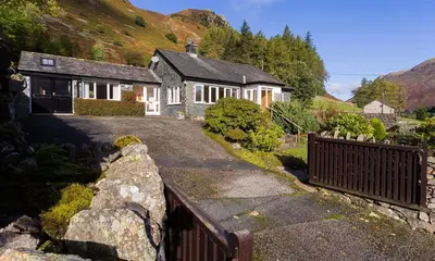 a house with a fence in front of it at Felldale in Glenridding