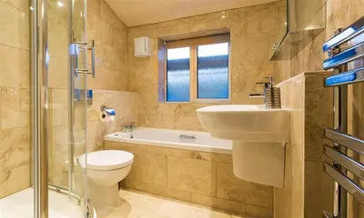 a bathroom with a toilet and a sink and a shower at Heathfield in Keswick