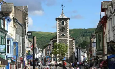 a town with a clock tower in the middle of a street at Heathfield in Keswick