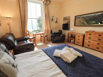 a bedroom with a bed and a living room at Easedale in Grasmere