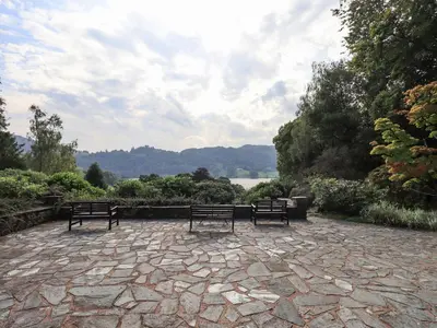 three benches sitting on a stone patio in a park at Easedale in Grasmere