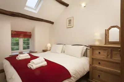 a bedroom with a large bed with towels on it at Wythebank in Ambleside