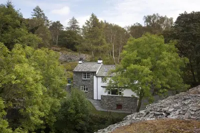 a house in the middle of a forest at Wythebank in Ambleside