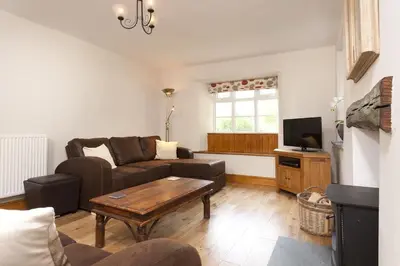 a living room with a couch and a table at Wythebank in Ambleside